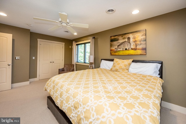 bedroom featuring light carpet, a closet, and ceiling fan