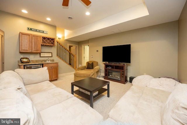 carpeted living room with ceiling fan