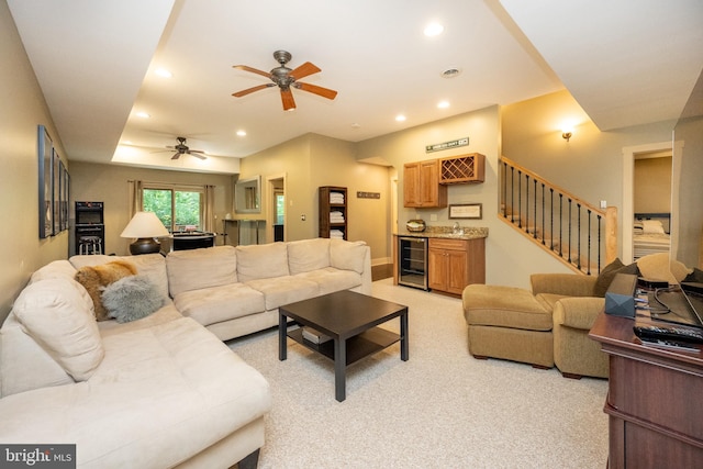 living room featuring ceiling fan, wine cooler, and light carpet