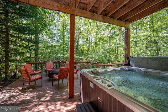 wooden terrace with a hot tub