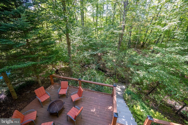 wooden terrace featuring a fire pit