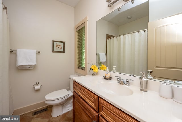 bathroom featuring tile patterned floors, vanity, and toilet