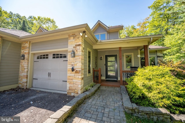 view of front of property with a garage and covered porch