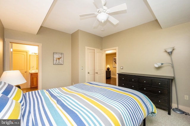 carpeted bedroom featuring connected bathroom, ceiling fan, and a closet