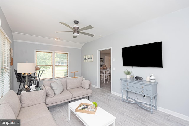 living room featuring light hardwood / wood-style flooring and ceiling fan