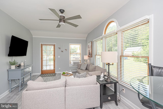 living room with a healthy amount of sunlight, ceiling fan, and light wood-type flooring