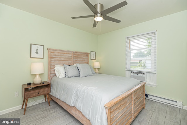 bedroom featuring cooling unit, ceiling fan, baseboard heating, and light hardwood / wood-style floors