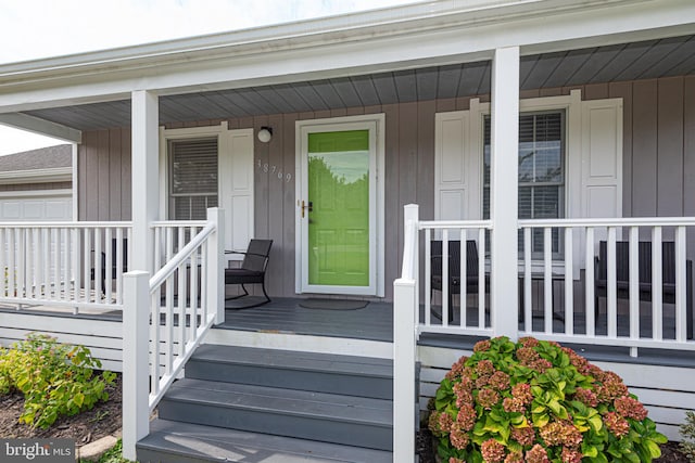 view of exterior entry featuring a porch