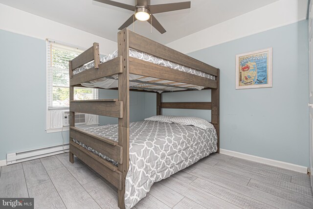 bedroom featuring a baseboard heating unit, hardwood / wood-style floors, cooling unit, and ceiling fan