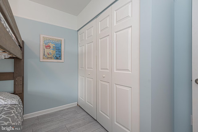 bedroom featuring light wood-type flooring and a closet