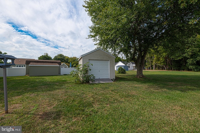 view of yard featuring an outbuilding and a garage