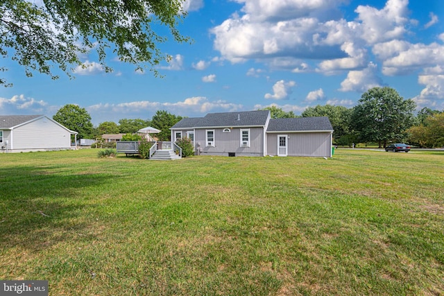 rear view of house featuring a lawn