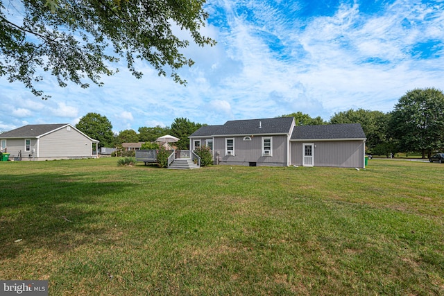 rear view of property featuring a yard