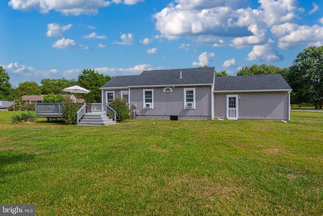 rear view of property with a yard and a deck