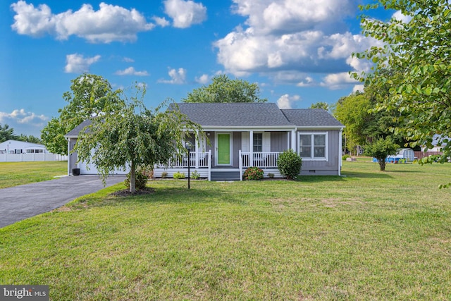 single story home with a front lawn and covered porch