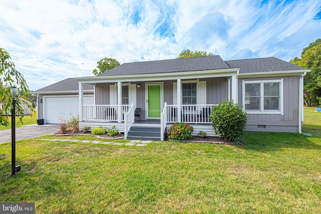 view of front of home featuring a garage, a front yard, and covered porch