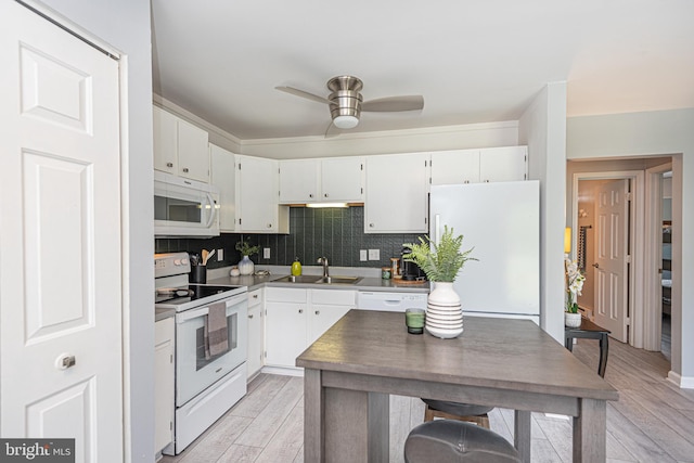 kitchen with white appliances, light hardwood / wood-style floors, sink, white cabinetry, and ceiling fan