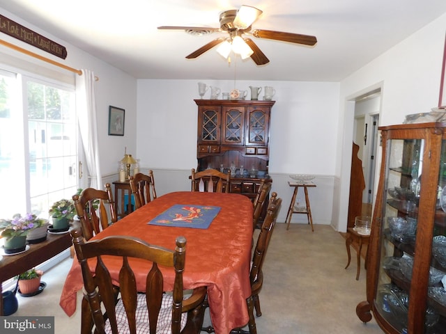 dining area featuring light carpet and ceiling fan