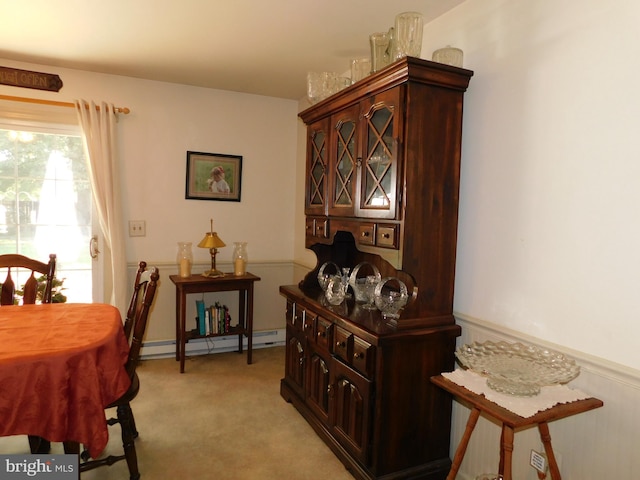 interior space with a baseboard radiator and light carpet