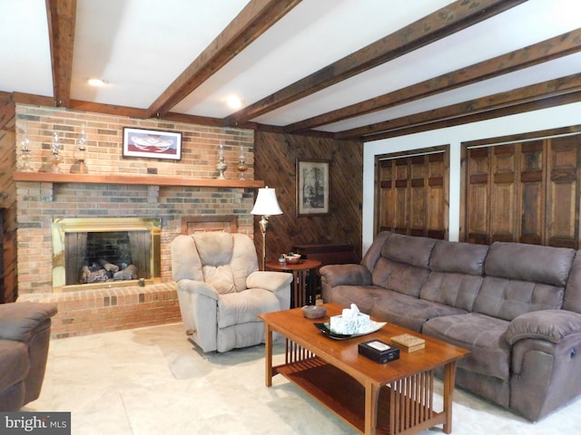 living room featuring wooden walls, beam ceiling, and a fireplace