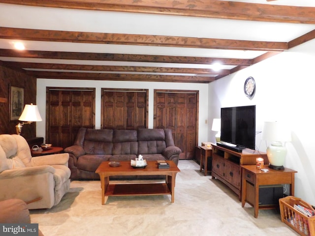 living room with light carpet and beamed ceiling