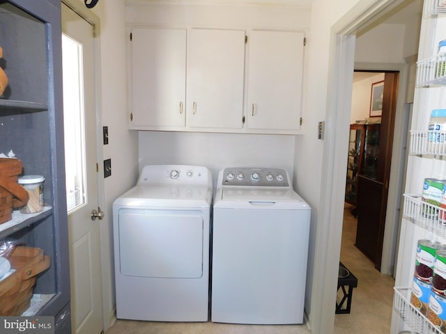 laundry area with cabinets, light carpet, and washer and dryer