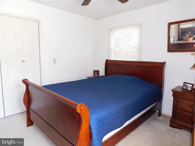 carpeted bedroom featuring a closet and ceiling fan