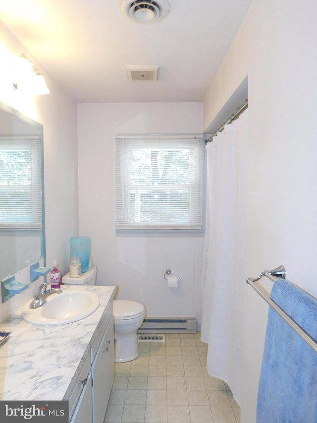 bathroom featuring vanity, baseboard heating, tile patterned flooring, and toilet