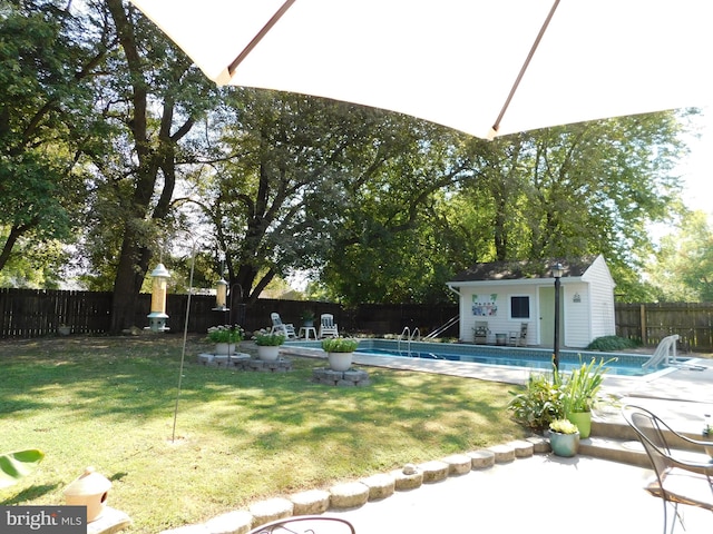 view of yard featuring an outbuilding and a fenced in pool