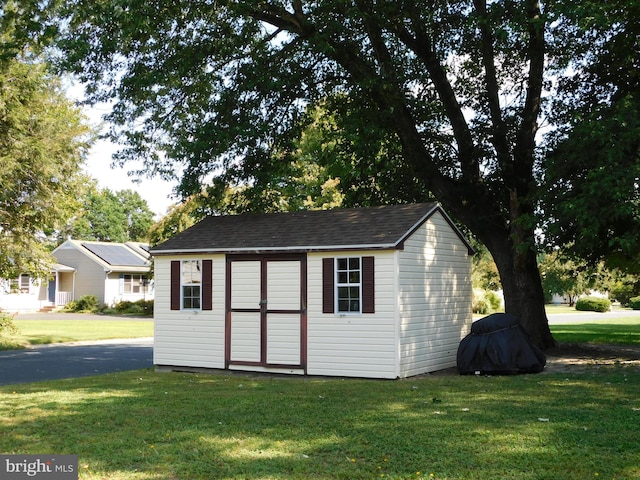 view of outdoor structure with a lawn