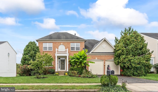 view of front of home with a front yard and a garage