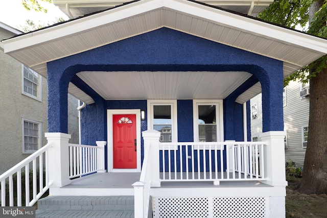 property entrance featuring a porch