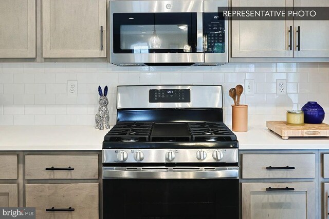 kitchen featuring appliances with stainless steel finishes and tasteful backsplash