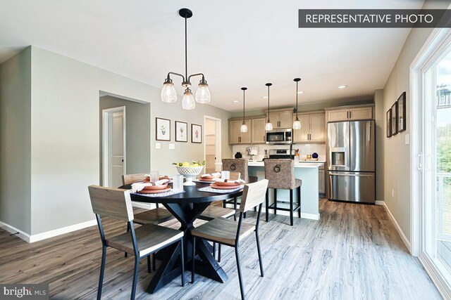 dining area featuring a chandelier and wood-type flooring