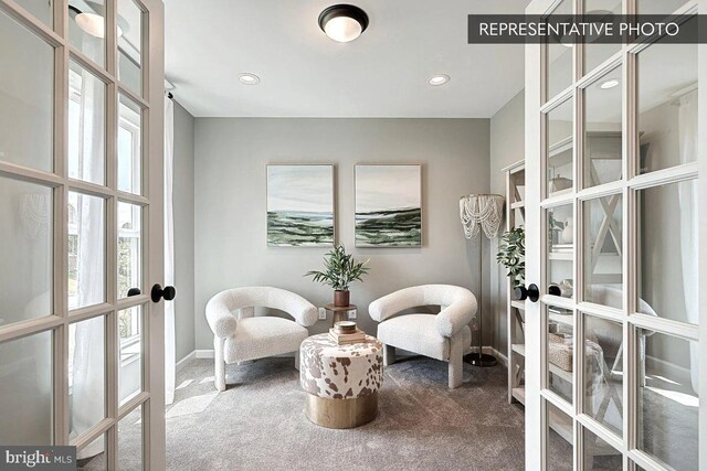 sitting room with french doors and carpet