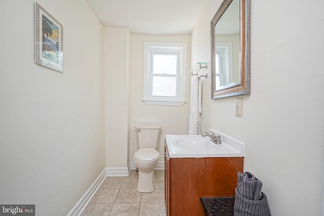 bathroom featuring tile patterned flooring, vanity, and toilet