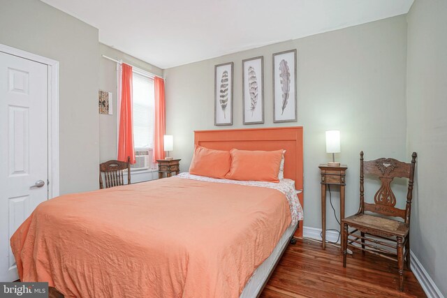 bedroom with dark wood-type flooring