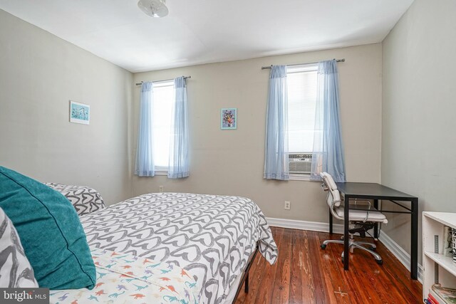 bedroom with dark wood-type flooring