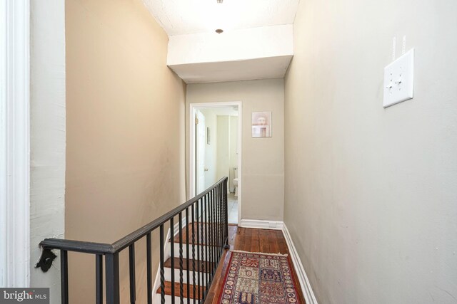 corridor with hardwood / wood-style floors