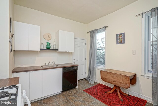 kitchen with white cabinets, black dishwasher, white stove, wood counters, and sink