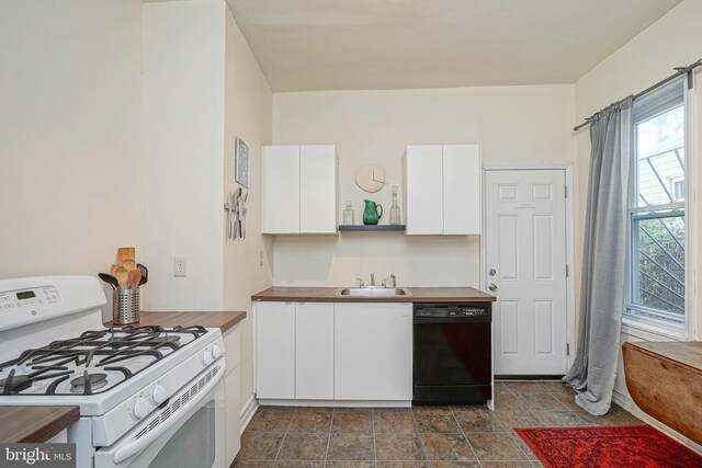 kitchen with white range with gas stovetop, black dishwasher, sink, and white cabinets