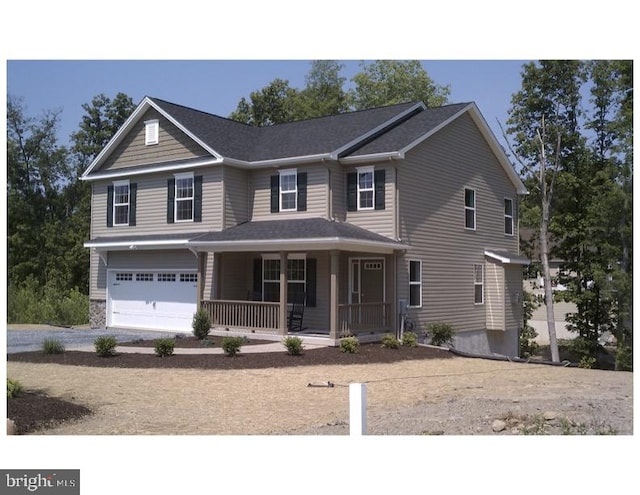 view of front of property featuring a garage and a porch