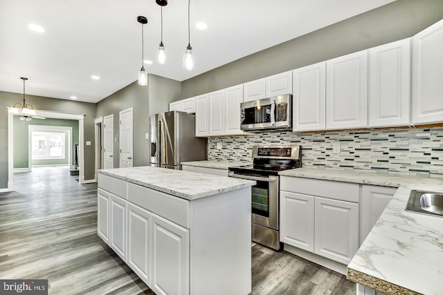 kitchen featuring a kitchen island, stainless steel appliances, and white cabinets