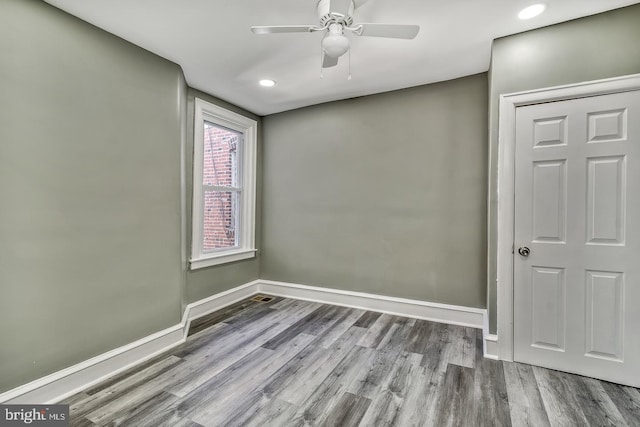 spare room with ceiling fan and wood-type flooring