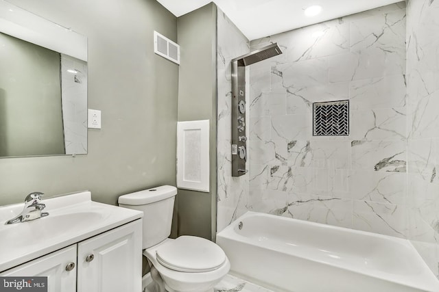 full bathroom featuring vanity, toilet, and tiled shower / bath combo