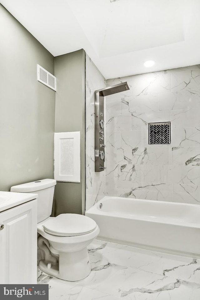 full bathroom with tiled shower / bath, toilet, and vanity