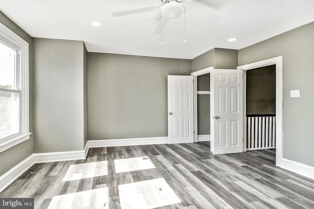 interior space with wood-type flooring and ceiling fan