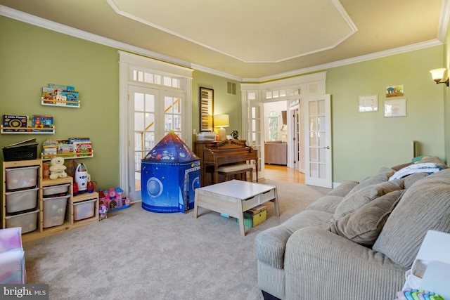 living room with crown molding, french doors, and carpet flooring