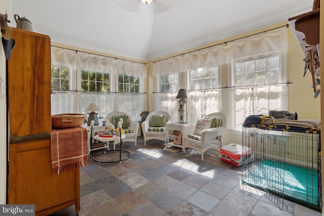 sunroom with vaulted ceiling and a healthy amount of sunlight