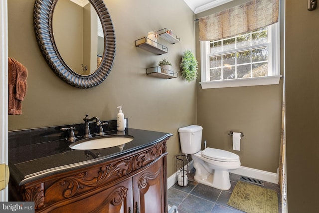 bathroom featuring crown molding, vanity, toilet, and tile patterned flooring